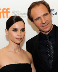 Cast members Felicity Jones and Ralph Fiennes pose on the red carpet before a screening of 'The Invisible Woman' at The Visa Screening Room during the 38th Toronto International Film Festival