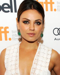 Cast member Mila Kunis poses on the red carpet before a screening of her film 'Third Person' at the Visa Screening Room during the 38th Toronto International Film Festival in Toronto