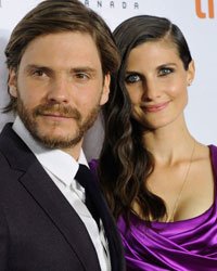 Cast member Daniel Bruehl poses on the red carpet with girlfriend Felicitas Rombold before a screening of the film 'Rush' at Roy Thomson Hall during the 38th Toronto International Film Festival