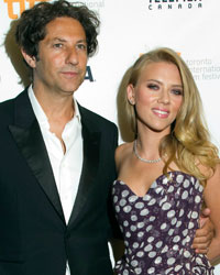 Cast member Scarlett Johansson and director Jonathan Glazer arrive for the film premier of 'Under The Skin' at the 38th Toronto International Film Festival in Toronto