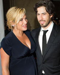 Cast member Kate Winslet, who is pregnant, greets director Jason Reitman as they arrive for the 'Labor Day' film screening at the 38th Toronto International Film Festival in Toronto