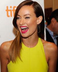 Cast members Adrien Brody and Olivia Wilde laugh on the red carpet before a screening of their film 'Third Person' at the Visa Screening Room during the 38th Toronto International Film Festival in Toronto