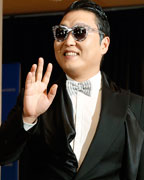 South Korean rapper Psy waves on the red carpet at the annual White House Correspondents' Association dinner in Washington