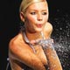 A model blows glitter from the end of the catwalk during a show at the Australian Fashion Week in Sydney.