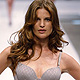 Models present creations by Triumph during the Berlin Fashion Week Spring/Summer 2012