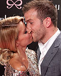 The Netherland's national soccer player Rafael van der Vaart kisses his wife Sylvie at Berlin Fashion Week