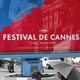 People sit on the pavement of La Croisette in Cannes in front of an official poster advertising the 58th International Film Festival in Cannes.