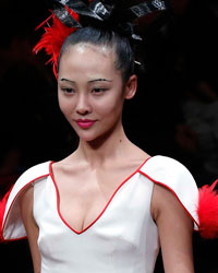 A model presents a creation from NE-TIGER Haute Couture Collection at China Fashion Week S/S 2014 in Beijing