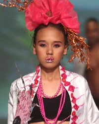 A model presents a creation by designers Meleesa Payne and Jason Shurland during the first runway show of the inaugural Guyana Fashion Week at Rahaman's Park in Houston