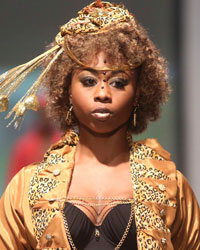 A model presents a creation by designers Meleesa Payne and Jason Shurland during the first runway show of the inaugural Guyana Fashion Week at Rahaman's Park in Houston