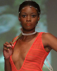 A model presents a creation by designer Wynette Jones during the first runway show of the inaugural Guyana Fashion Week at Rahaman's Park in Houston