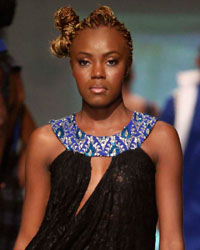 A model presents a creation by designer Andy Cummings during the first runway show of the inaugural Guyana Fashion Week at Rahaman's Park in Houston, Guyana