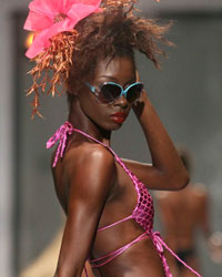 A model presents a creation by Meleese Payne during the second runway show of Guyana Fashion Week at Rahaman's Park in Houston