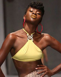 A model presents a creation by Meleese Payne during the second runway show of Guyana Fashion Week at Rahaman's Park in Houston