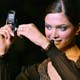 A model displays a Samsung's D-500 cellular telephone at its launch during week-long fashion shows 