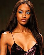 Model Jourdan Dunn presents a creation from the Unique for Top Shop Autumn-Winter 2013 collection during London Fashion Week