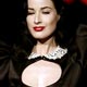 Burlesque artiste Dita Von Teese, wife of U.S. musician Marilyn Manson performs at the begining of Moschino Cheap & Chic Fall/Winter 2006/07 women's collections show during Milan's fashion week