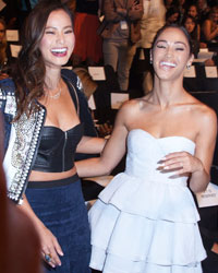 Actresses Jamie Chung (L) and Cara Santana pose for photographers before the presentation of the BCBG Max Azria Spring/Summer 2014 collection during New York Fashion