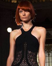 A model presents a creation from the threeASFOUR Spring/Summer 2014 collection during New York Fashion Week