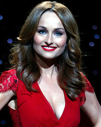 Television personality Giada De Laurentiis presents a creation by Carolina Herrera for the The Heart Truth Fall 2014 collection during New York Fashion Week