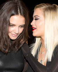 Actress Katie Holmes (L) and singer Rita Ora arrive for the Donna Karan New York show during New York Fashion Week