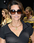 Actress Gina Gershon poses for photographs before the presentation of the Edun Spring-Summer 2013 collection during New York Fashion Week