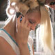 A model talks on her cell phone while getting her hair done backstage before the Twinkle show at Fashion Week in New York.