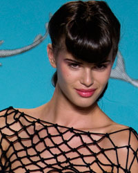 A model presents a creation by designer Olympia Le-Tan as part of her Spring-Summer 2014 women's ready-to-wear for fashion show during Paris fashion week