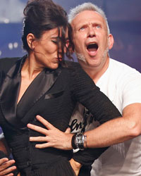 French designer Jean Paul Gaultier appears with Spanish ballet dancer Blanca Li at the end of his Spring/Summer 2014 women's ready-to-wear fashion show during Paris fashion week