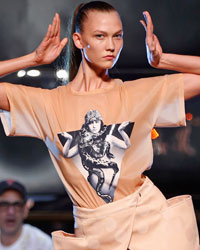 Model Karlie Kloss presents a creation by French designer Jean Paul Gaultier as part of his Spring/Summer 2014 women's ready-to-wear fashion show during Paris fashion week