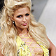 U.S. socialite Paris Hilton presents a creation by Ukrainian designer Andre Tan during Ukrainian Fashion Week in Kiev