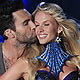 Adam Levine, lead singer of Maroon 5, kisses model Anne Vyalitsyna during the Victoria's Secret Fashion Show