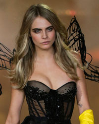 Model Cara Delevingne presents a creation during the annual Victoria's Secret Fashion Show in New York