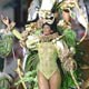 Spectators look on from the VIP stands as revelers dance atop a float of the Mocidade Independente samba school at the start of the premier Carnival parades, at the Sambadrome.