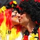 Two German soccer fans kiss before the World Cup 2006 opening ceremony in Munich