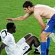 Italy's Simone Perrotta consoles John Mensah after Italy defeated Ghana in Group E