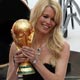 Pele watches as German model Schiffer holds the World Cup trophy during the World Cup 2006 opening ceremony in Munich