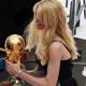 Pele and Claudia Schiffer hold the World Cup Trophy