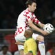 Croatias Darijo Srna jumps for ball behind Roberto Carlos during Group F World Cup 2006 soccer match