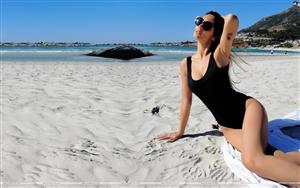 Swimsuit-clad Bruna Abdullah vacationing on white sand beach