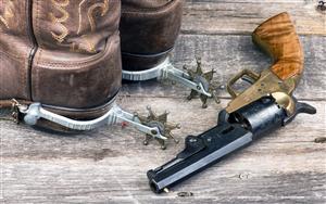 Old western pistol and cowboy boots