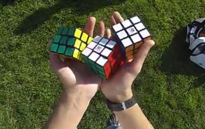 Solving Three Rubik's Cubes while Juggling