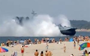 Military Hovercraft Lands On Busy Beach