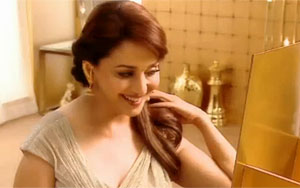 Madhuri Dixit likes to be bold. At an age, where most women would be busy with either home and hearth, the sizzling actress has gone backless for an ad film. For the first time in her career, Mads has exposed her back like never before, all for the lure of the yellow metal.<br>With Diwali, around the corner, the Dancing Diva took out her selected pieces and posed before the lens, all in anticipation of the festival of lights and celebration of Goddess Laxmi.<br>
Draped in gold, and wearing her dazzling jewellery, the smile on Madhuri`s face was a joy to watch as she looked into the mirror many a time to ask, `Mirror, mirror on the wall, who is the prettiest of them all.`