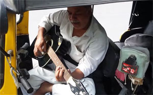 Mumbai Autowallah Playing a Guitar