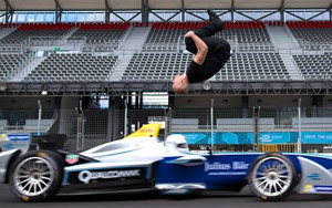 Daredevil Backflips Over Speeding Formula Race Car