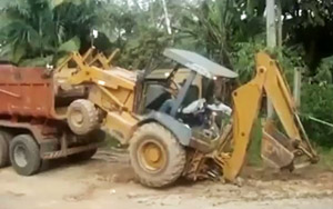 Loading a Backhoe Into a Dump Truck