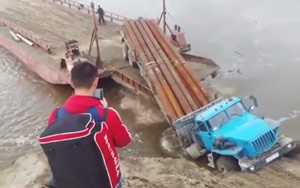 Loaded Truck Tumbles Into A River