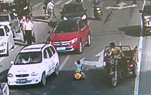 Kid Drives Toy Car Through Traffic on Busy Road